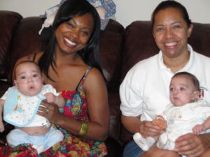 NICU Mothers sitting on a sofa together, holding their babies on their laps